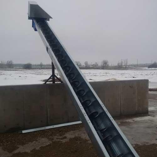 FDI manure auger riser outside a layer barn